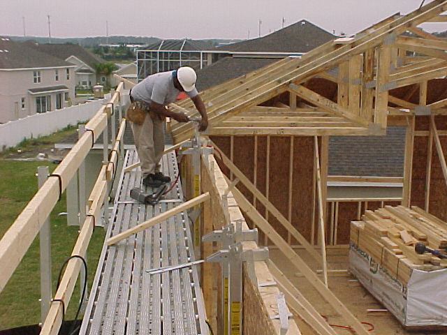 Wall Walker top plate bracket scaffold in use setting roof trusses