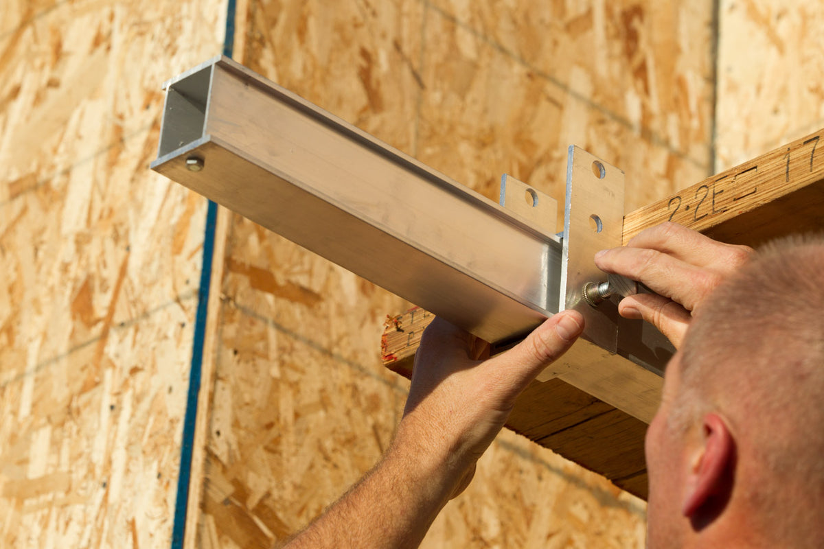 Securing planks to the Wall Walker arm with plank brackets